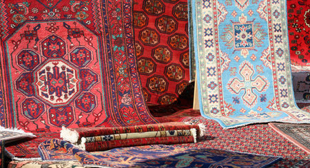 stall with many woven Middle Eastern wool rugs for sale in the outdoor marketの写真素材
