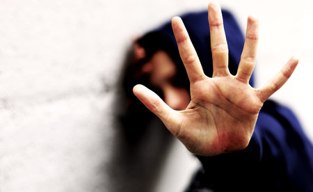 hand of the young girl trying to protect herself from violence with dramatic effect colors