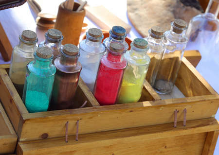 many glass bottles with liquid pigments and dyes used to color fabrics in medieval timesの写真素材