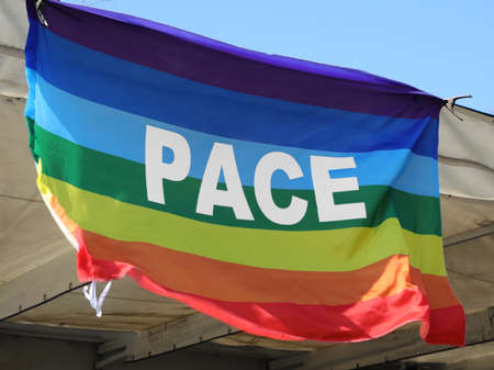 multicolored flag with the big Italian word PACE which means peace and symbolizes non-violence and no warの写真素材