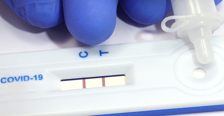 medical tool for test covid-19 test with positive result on white background