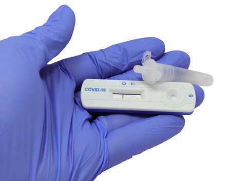 hand with latex glove holding test tube and medical device for covid-19 test with negative result...