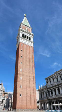 very high bell tower in the square of Saint Mark called San Marco which is the symbol of the island of Venice in Northern Italyの写真素材