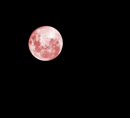 Red full moon on the absolutely black sky at midnightの写真素材