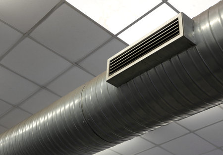 large pipe of the air conditioning system in the factory and the nozzle for the outlet of hot or...