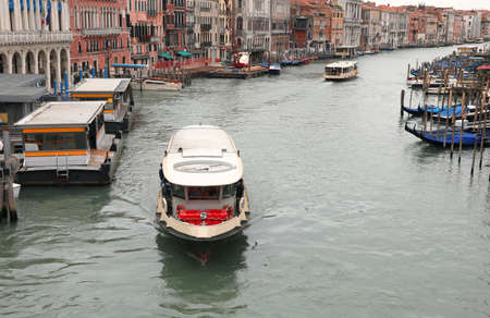 Ferry boat called vaporetto for the transport of people to the island of Venice in the Grand Canal without other boats sailing because during the lockdown it was forbidden to circulateの写真素材