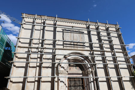 Ancient church of the city of L AQUILA in Central Italy damaged by the earthquake and now completely covered with scaffolding during the construction of the maintenance worksの写真素材