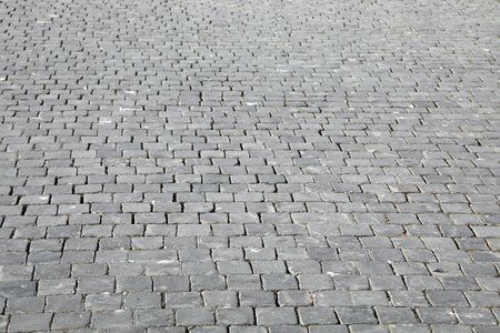Background of many gray cobbles called SANPIETRINI in Italian language in the square
