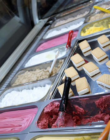 ice cream cookies and tubs of ice cream of various flavors in the tropical beach ice cream parlor in summerの写真素材