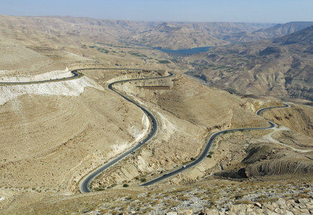 winding asphalt road that climbs into the rocky mountain is all around the desert in the Middle Eastern area between Europe and Asiaの写真素材