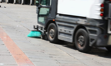 intentionally moved moving van to clean the city square with large industrial brushes
