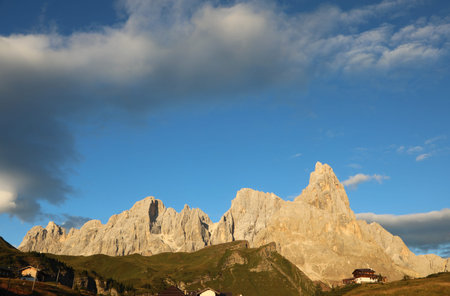 Italian Dolomites colored orange by optical phenomenona called Alpenglow which reflects the sun light at sunset near Rolle Passの写真素材