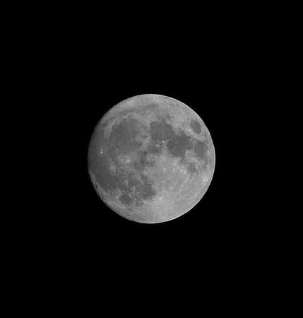 large full moon with clearly visible craters and the black sky aroundの写真素材