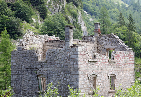 rubble of the ancient uninhabited stone house destroyed by the earthquake in the middle of the woodsの写真素材