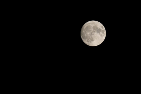Big Full moon in the black starless sky at nightの写真素材