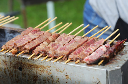 many skewers of sheep and mutton cooked over the burning embers called ARROSTICINI in the Italian languageの写真素材