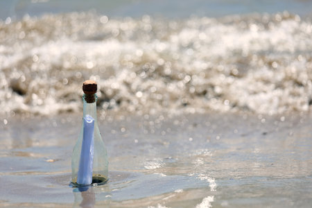 clear glass bottle with secret message inside by the seaの写真素材
