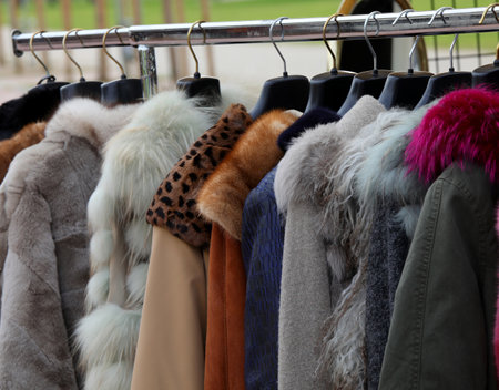 vintage used clothes and new dresses in the stall at the flea marketの写真素材