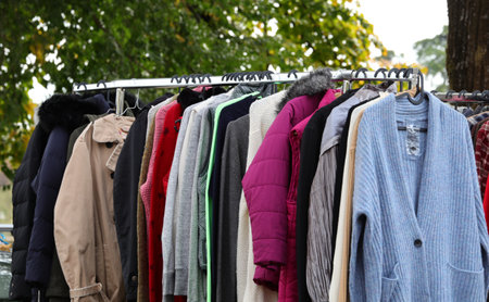 vintage used clothes and new dresses in the stall at the flea marketの写真素材