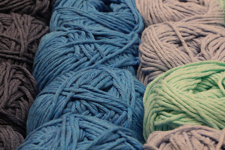 background of many balls of fabric for sale in haberdashery shop
