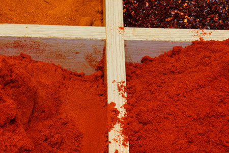 red paprika powder and other hot and exotic spices for sale at the marketの写真素材
