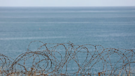 metal barbed wire from World War II with the English Channel in the backgroundの写真素材