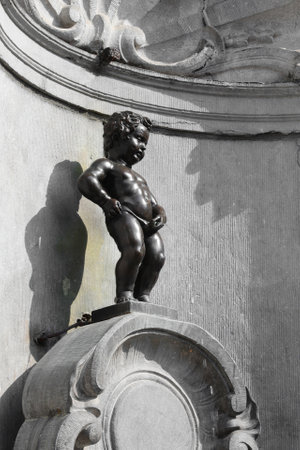Brussels, B, Belgium - August 18, 2022: Manneken Pis is a fountain with a statue of boy while pissingのeditorial素材