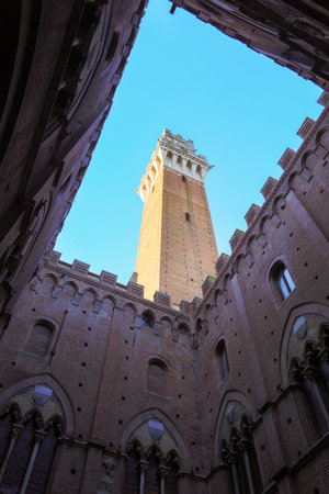 Siena, SI, Italy - February 20, 2023: famous tower called DEL MANGIA from the courtyard of the town hallのeditorial素材