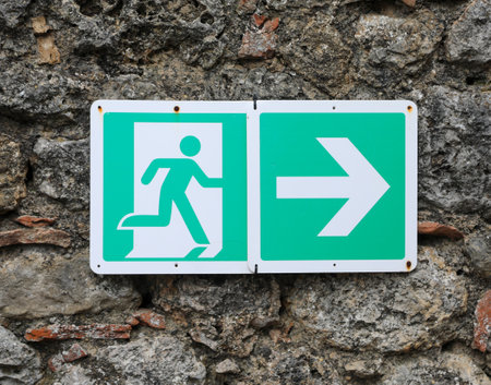 green emergency exit sign with the pictogram drawn with a stick figureの写真素材