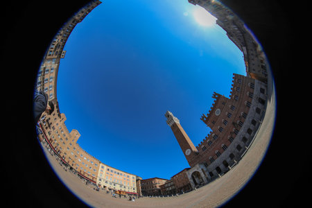 fisheye lens view of the Tower called TORRE DEL MANGIA in the main Piazza of SIENA in central Italyの写真素材