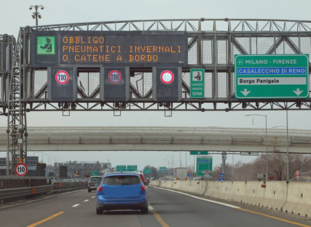 Wide Signal in the Motorway with text that means obligation winter equiment or snow chains in Italian Languageの写真素材