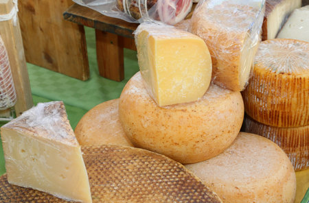 Seasoned cheeses made with sheep and cows milk and goat for sale at the marketの写真素材