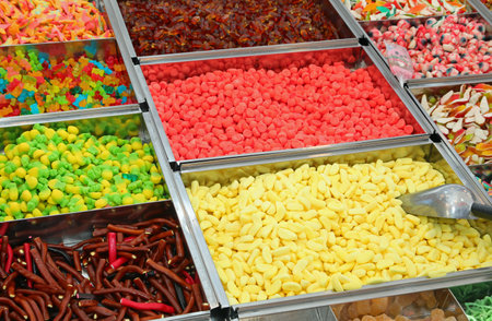 Candies of various flavors and very sugary and colorful dimensions for sale in the sweets stall at the fairの写真素材