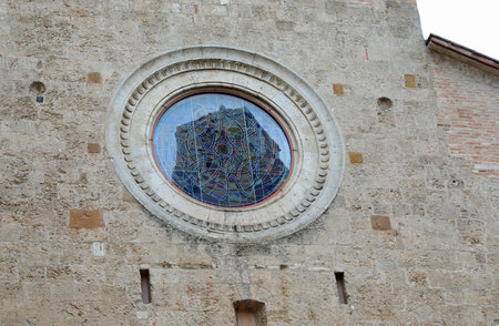 Reflect on the Church in the medieval village of SAN GIMIGNANO near Siena in Central Italyの写真素材