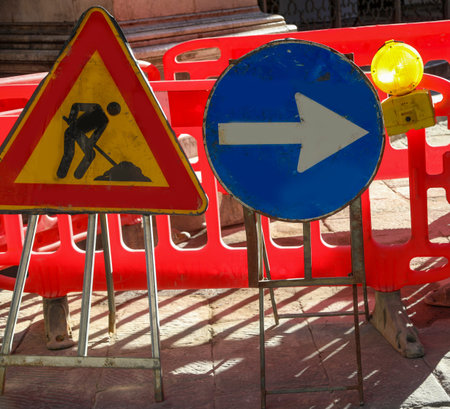 road construction site in the city and the signs with the big arrow