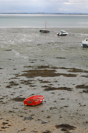 RED Beached Boat and some other boats during low tide in Franceの写真素材