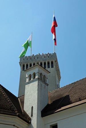 Ljubljana, L, Slovenia - August 15, 2023: Tower of ancient Castle called ljubljanski grad in Slovenian language and flagsのeditorial素材