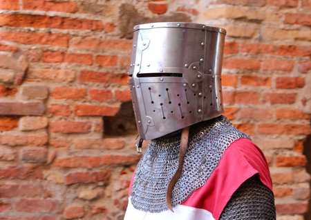 Medieval Knight With Armor And Metal Protective Helmet On Head During A Historical Reenactment