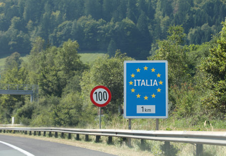 road sign on the highway on the border in Italy and the speed limit at 100 kmの写真素材