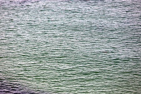 very simple background of sea water with light blue and blue shades without people and without boats...