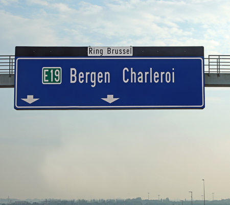 road sign of the Belgian highways near Brussels with the indication to the airport and the city of Bergenの写真素材