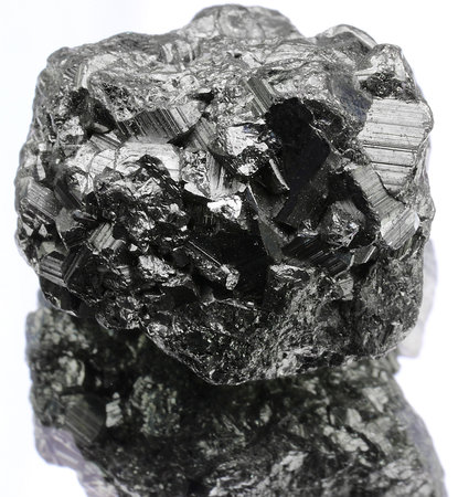 small gray shiny metallic nugget just found by searchers on the white background