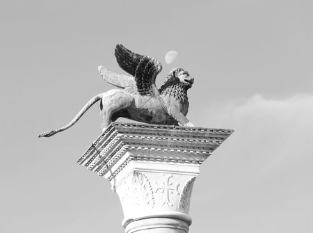 statue of the winged lion of saint mark symbol of the city of venice above the column with white and black effectの写真素材