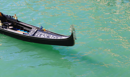bow of the Gondola the typical boat for transporting tourists in Venice in Italy in Europe on the water of the Grand Canalの写真素材