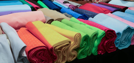 many cotton and felt fabrics for sale on the counter in the tailoring and drapery shop