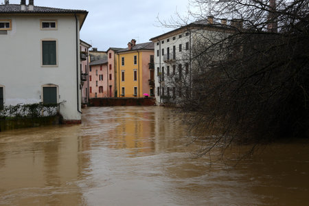 Arch of a bridge submerged by the swollen Retrone River in Vicenza in Northern Italy during a flood caused by climate changeの写真素材