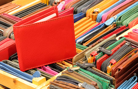 Red wallet and other leather zip wallets created by hand by the skilled craftsman for sale in the leather goods shopの写真素材