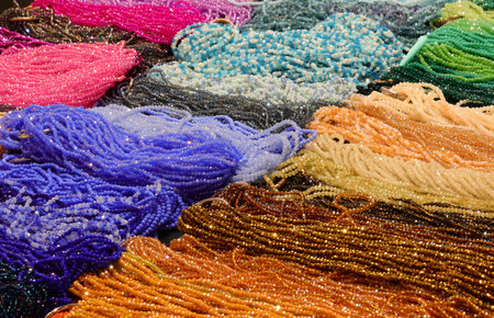 necklaces made of colored glass paste and strung on nylon thread in the shop selling fashion...
