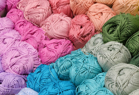 many balls of thread of various colors on sale in the knitwear and fabrics shop