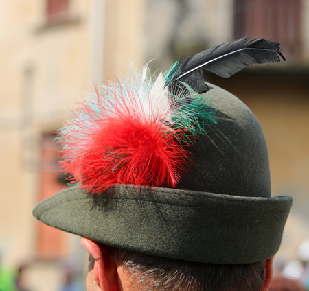person wearing a Black Feather Hat typical of the uniform of the Alpini the mountain troops of Italian Army and with a tricolor decorationの写真素材